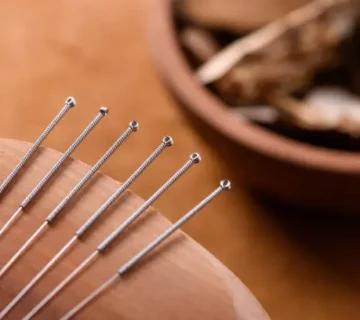Acupuncture needles on a wooden table